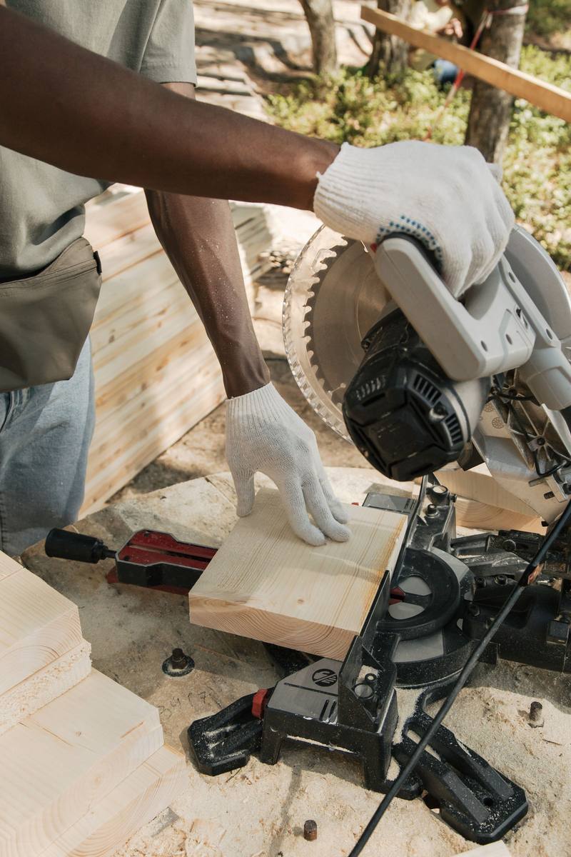 Carpenter cutting timber with a circular saw